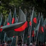 A vibrant display of Bangladesh flags during a national celebration outdoors.